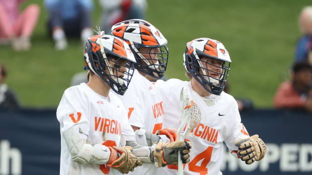 Truitt Sunderland, Payton Cormier, and Noah Chizmar celebrate after scoring a goal during the Virginia men's lacrosse game against Syracuse at Klockner Stadium.